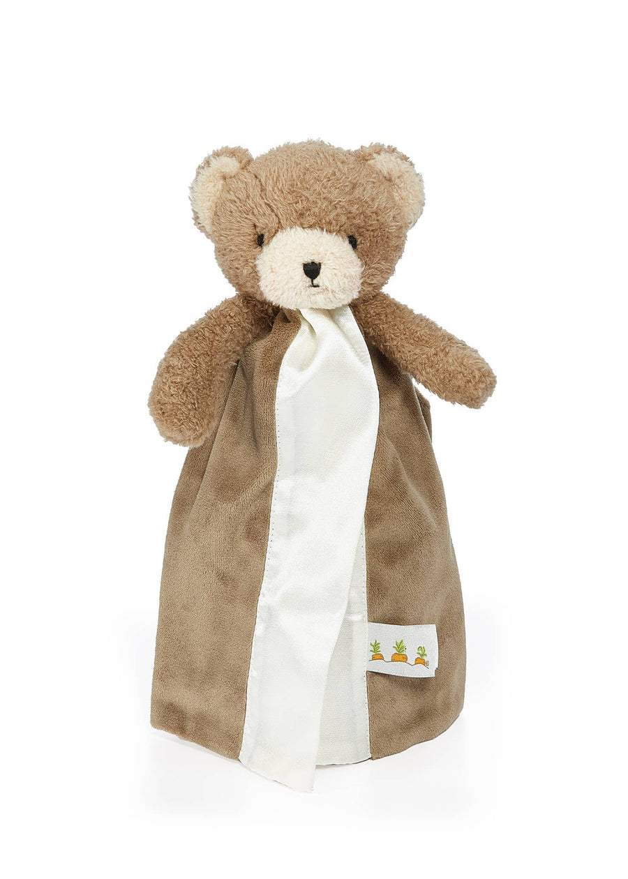 Brown teddy bear with a white blanket on a white background