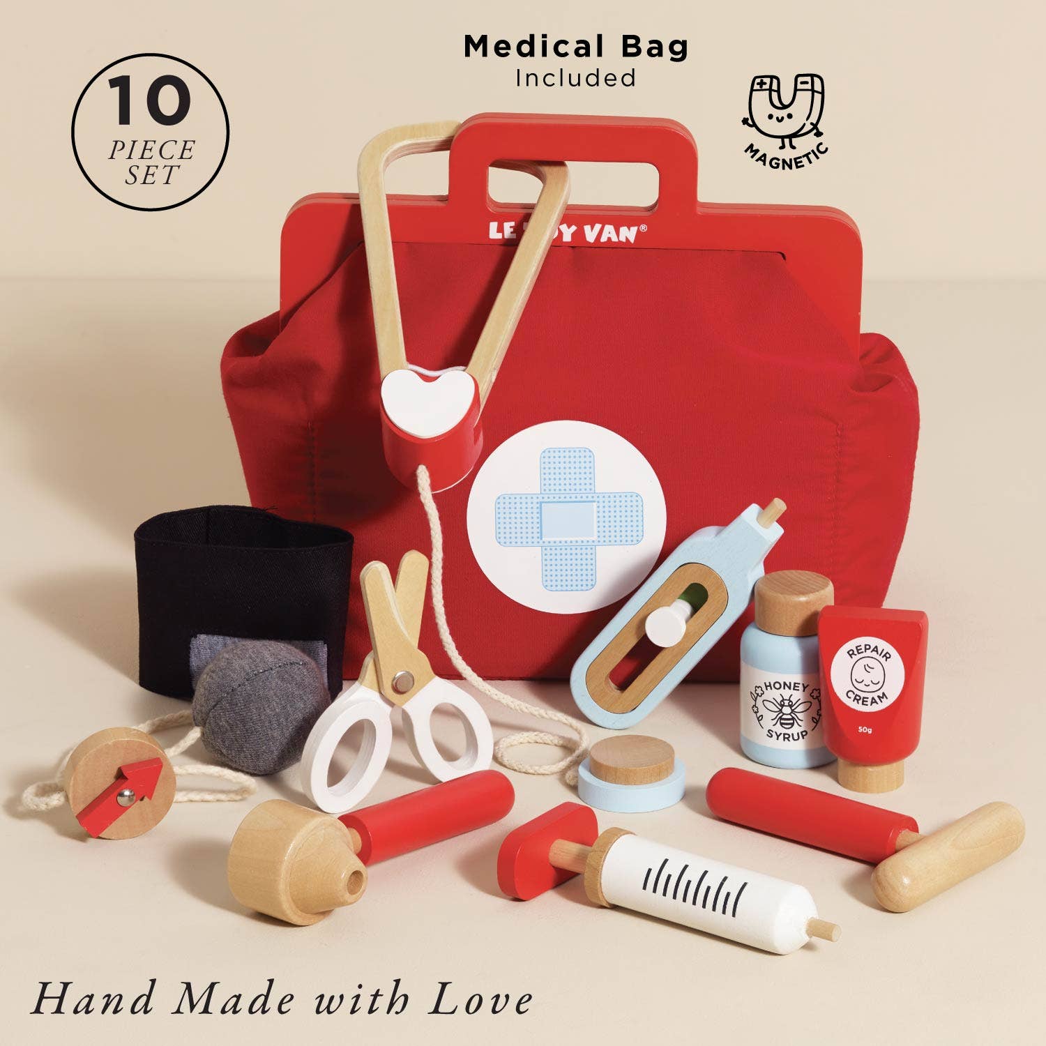 Toy medical kit with red bag, various toy medical items, and 'Hand Made with Love' text on a beige background.