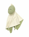 Green plush toy with a white blanket on a white background