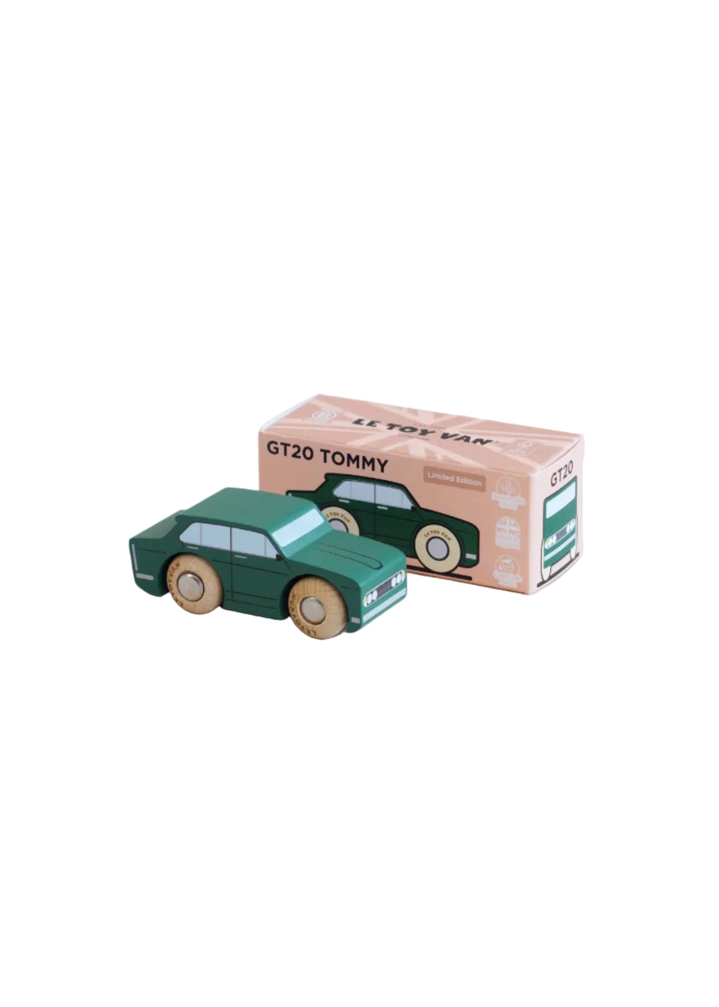Green toy car next to its packaging box on a beige background