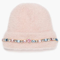Pink beanie with a decorative band featuring colorful crystals on a white background