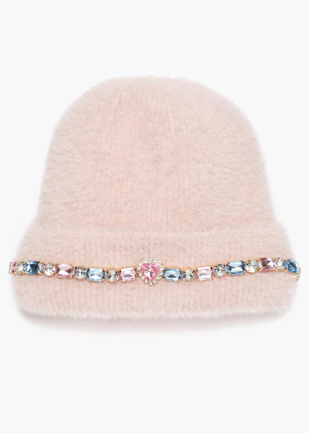 Pink beanie with a decorative band featuring colorful crystals on a white background