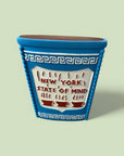 Blue ceramic planter with 'New York State of Mind' text on a light green background