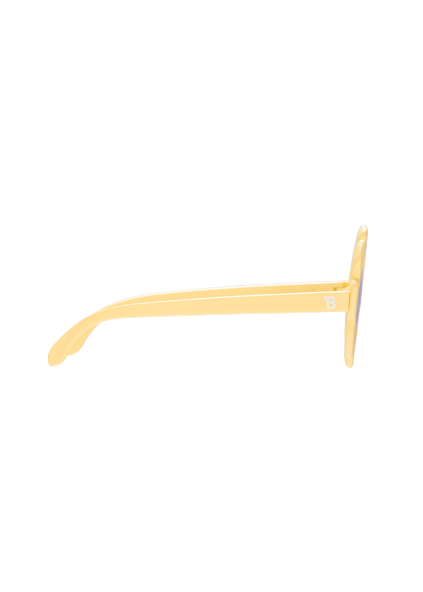 Yellow tongue scraper on a white background