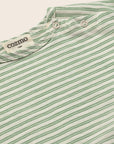 Close-up of a green and white striped shirt with 'cozmo' branding on a light background