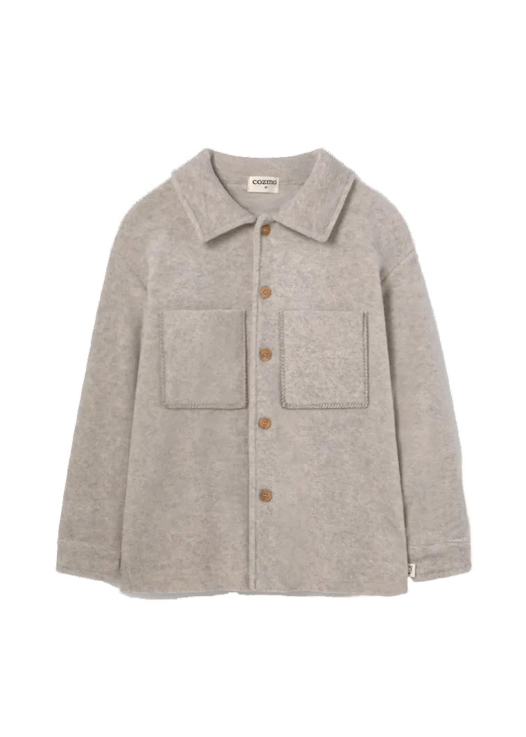 A light gray wool-blend button-up shirt jacket with a collar, two front patch pockets, and brown buttons, shown flat on a white background. The brand name 'comodo' is visible on the inner neck label.