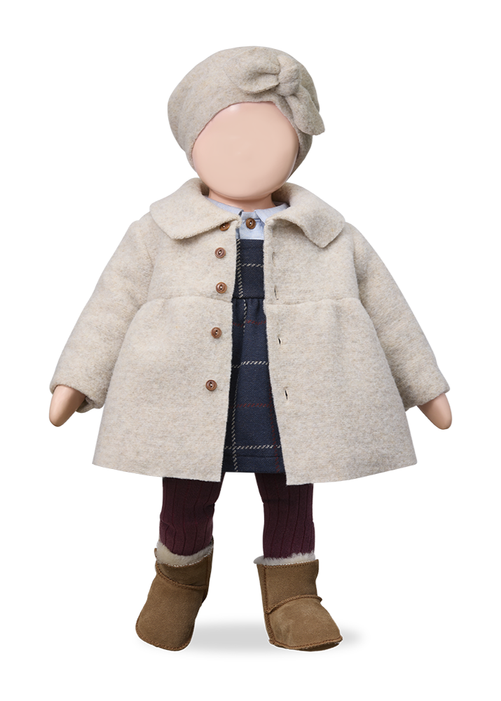 Doll wearing a beige coat, hat, and boots on a white background