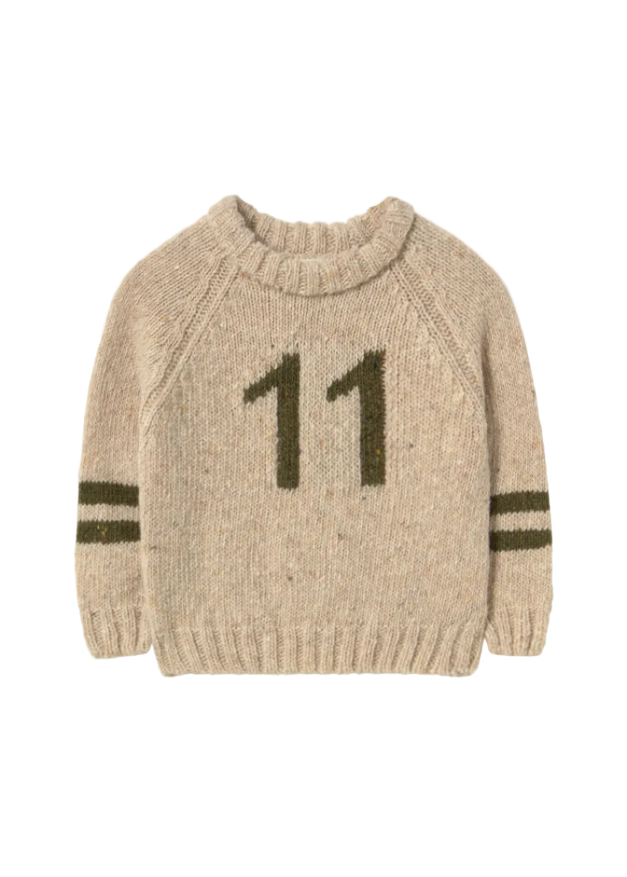 Beige sweater with number 11 on a light gray background