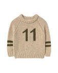 Beige sweater with number 11 on a light gray background