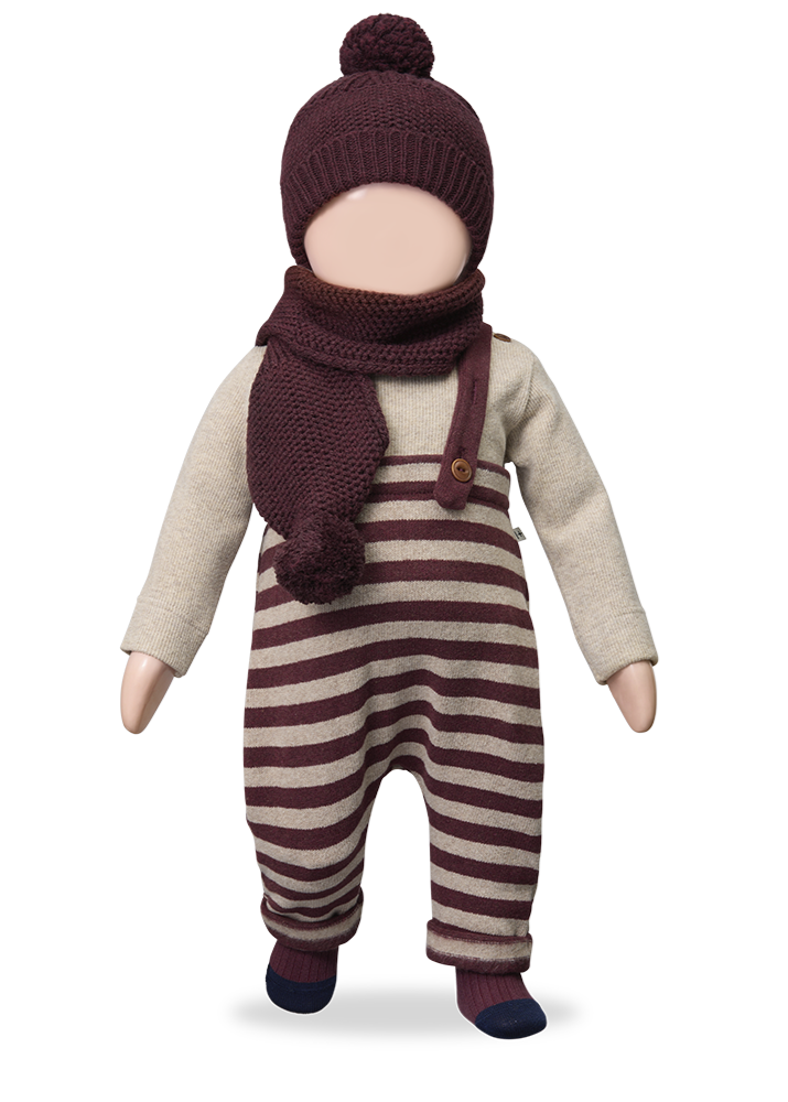 Doll wearing a striped outfit with a hat and scarf on a white background