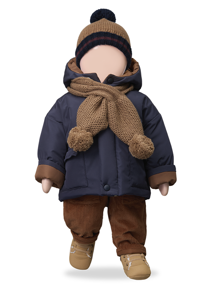 Doll wearing a navy coat, brown pants, and hat with a scarf on a white background