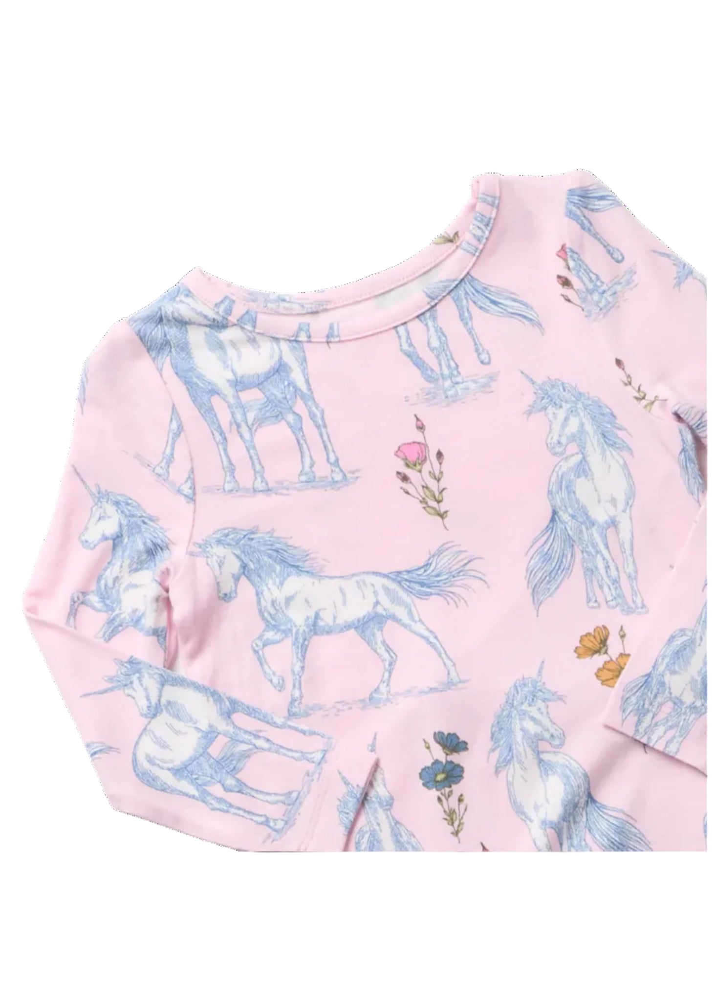 A close-up of a pink long-sleeve top featuring a repeating print of white unicorns and small floral details in blue, pink, and yellow.