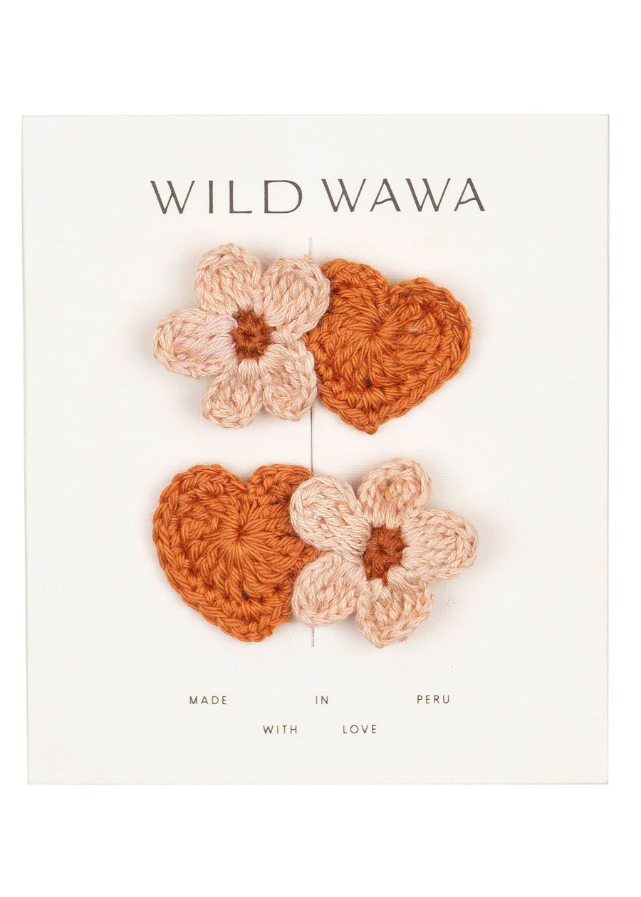 Crocheted flower and heart-shaped accessories with 'Wild Wawa' branding on a white background.