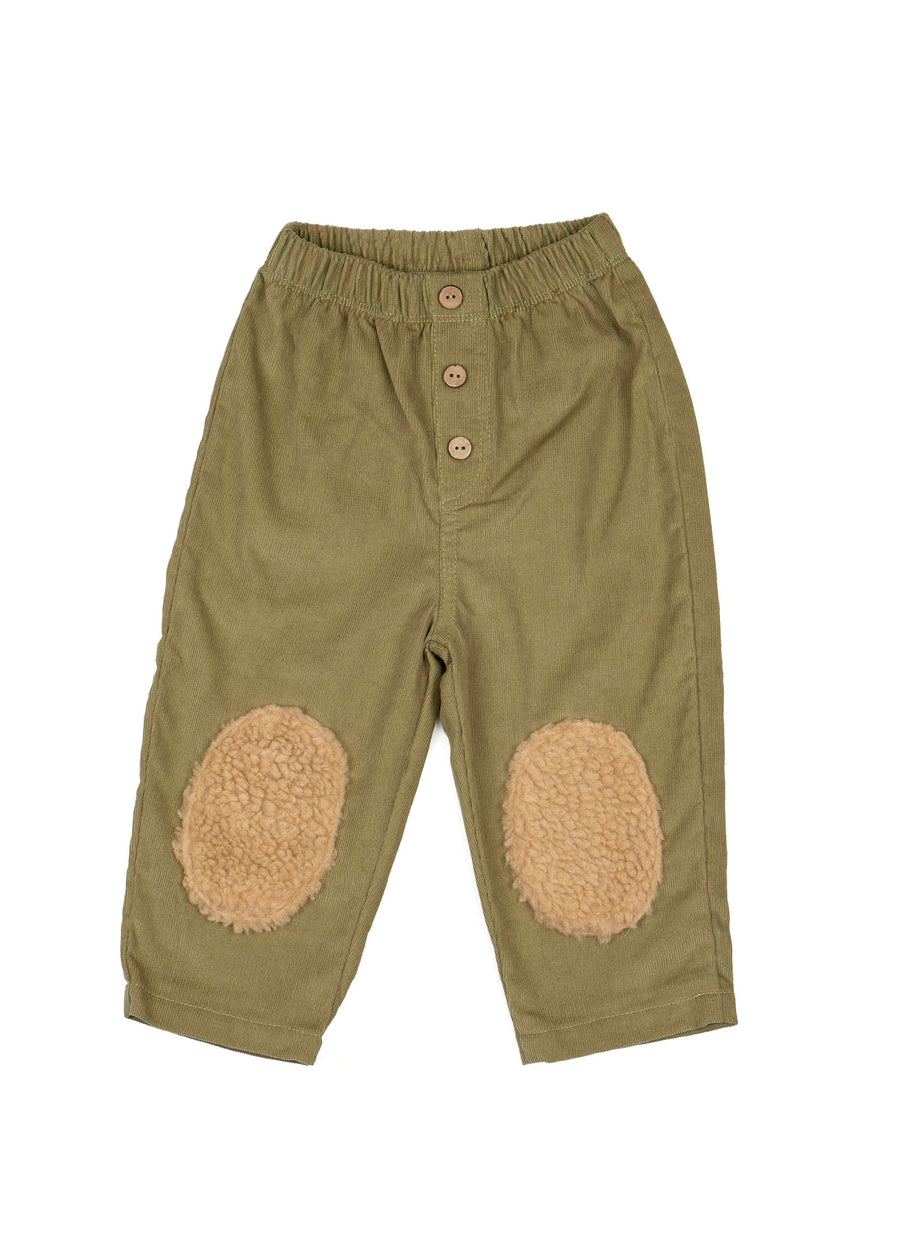 Green pants with beige patches on a white background