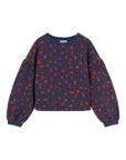 Navy blue sweater with red pattern on a light gray background