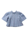A light blue blouse with a dense red and white floral print, featuring a smocked high neckline and voluminous short sleeves, shown flat on a white background.