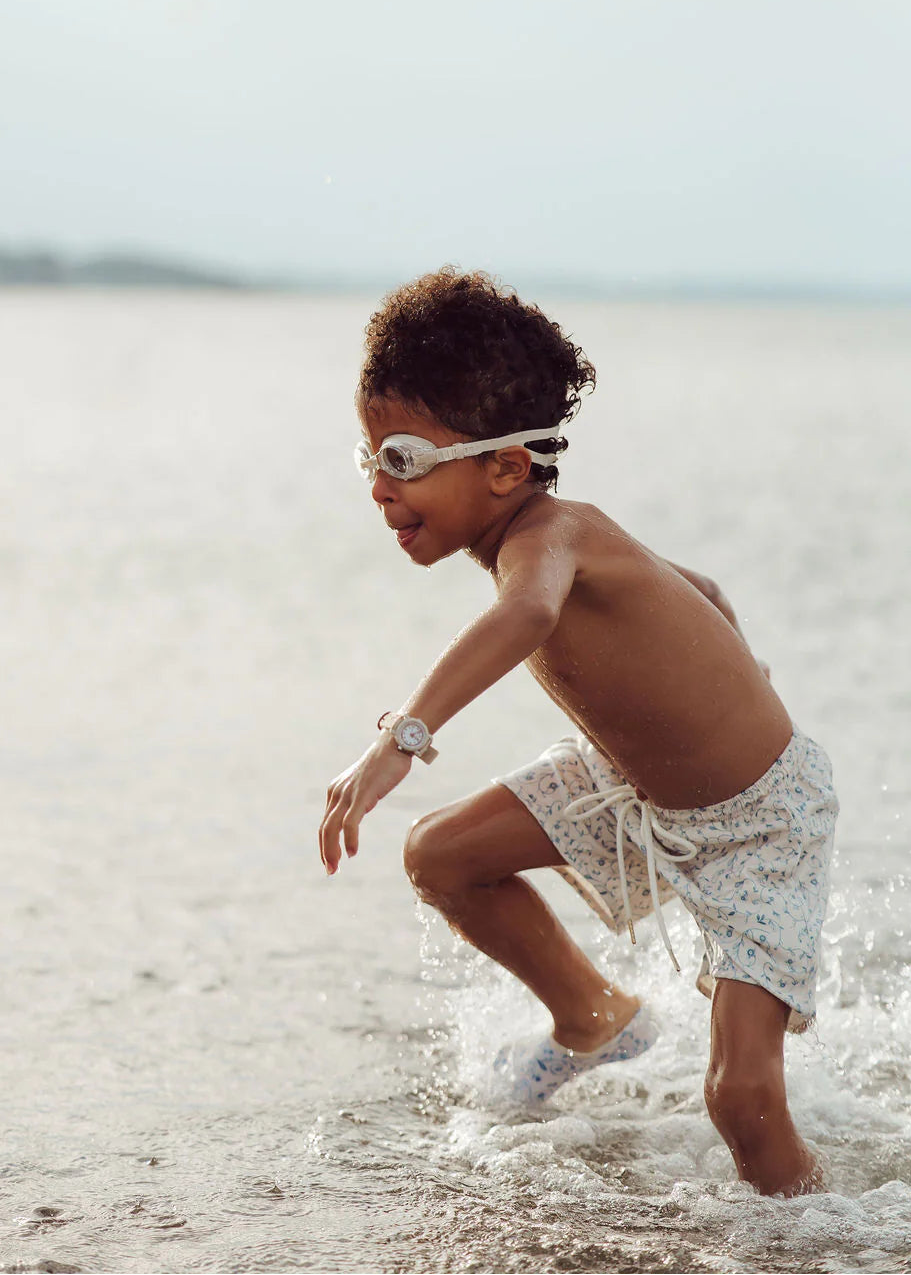 Child playing in shallow water at the beach