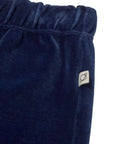 Navy blue fleece pants with a brand logo on a light gray background