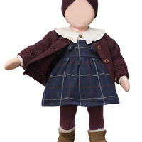 Doll wearing a plaid dress, brown cardigan, and boots on a white background