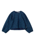 Blue patterned blouse on a white background