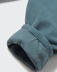 Close-up of a blue fabric edge on a light gray background