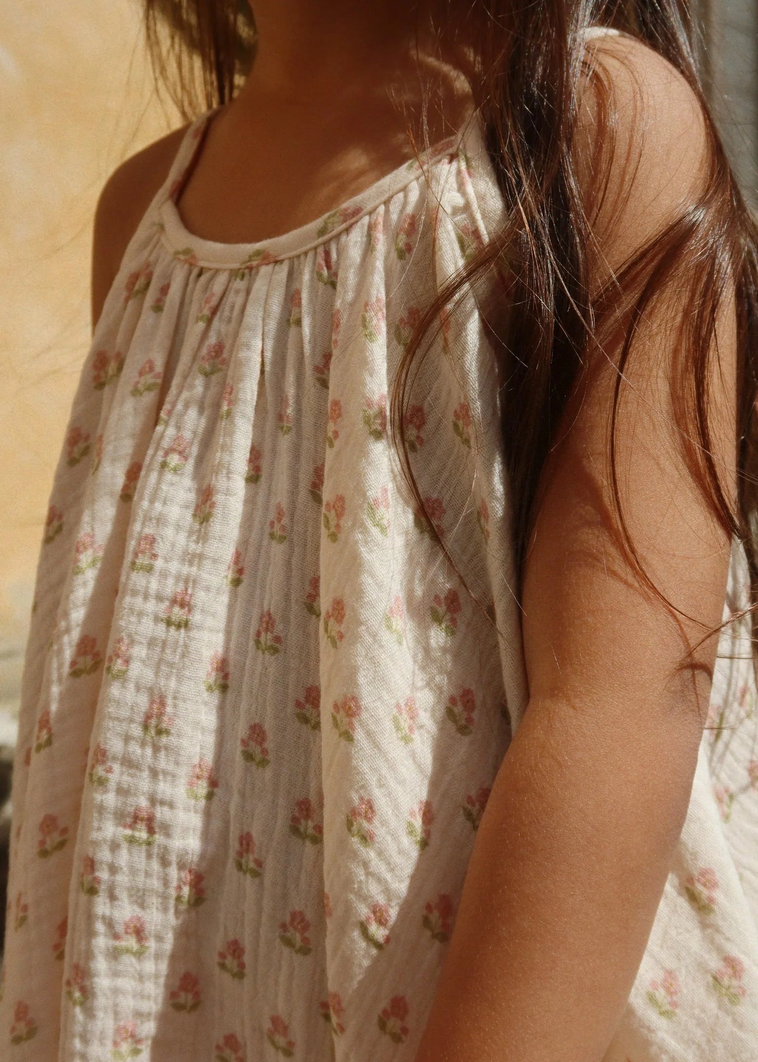 Person wearing a floral dress with a blurred background