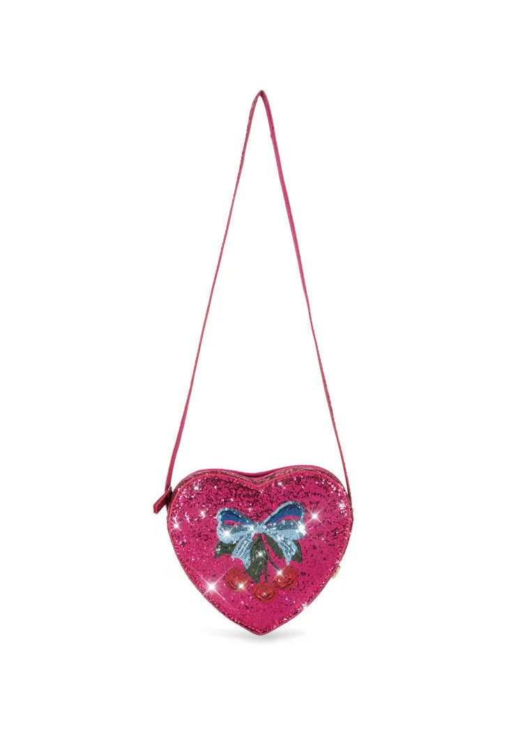 Heart-shaped pink purse with a blue bow on a white background