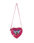 Heart-shaped pink purse with a blue bow on a white background