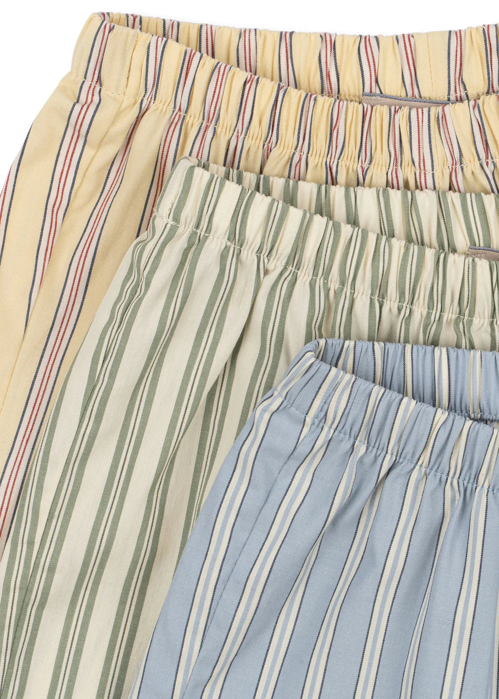 Three pairs of striped pants in beige, green, and blue.