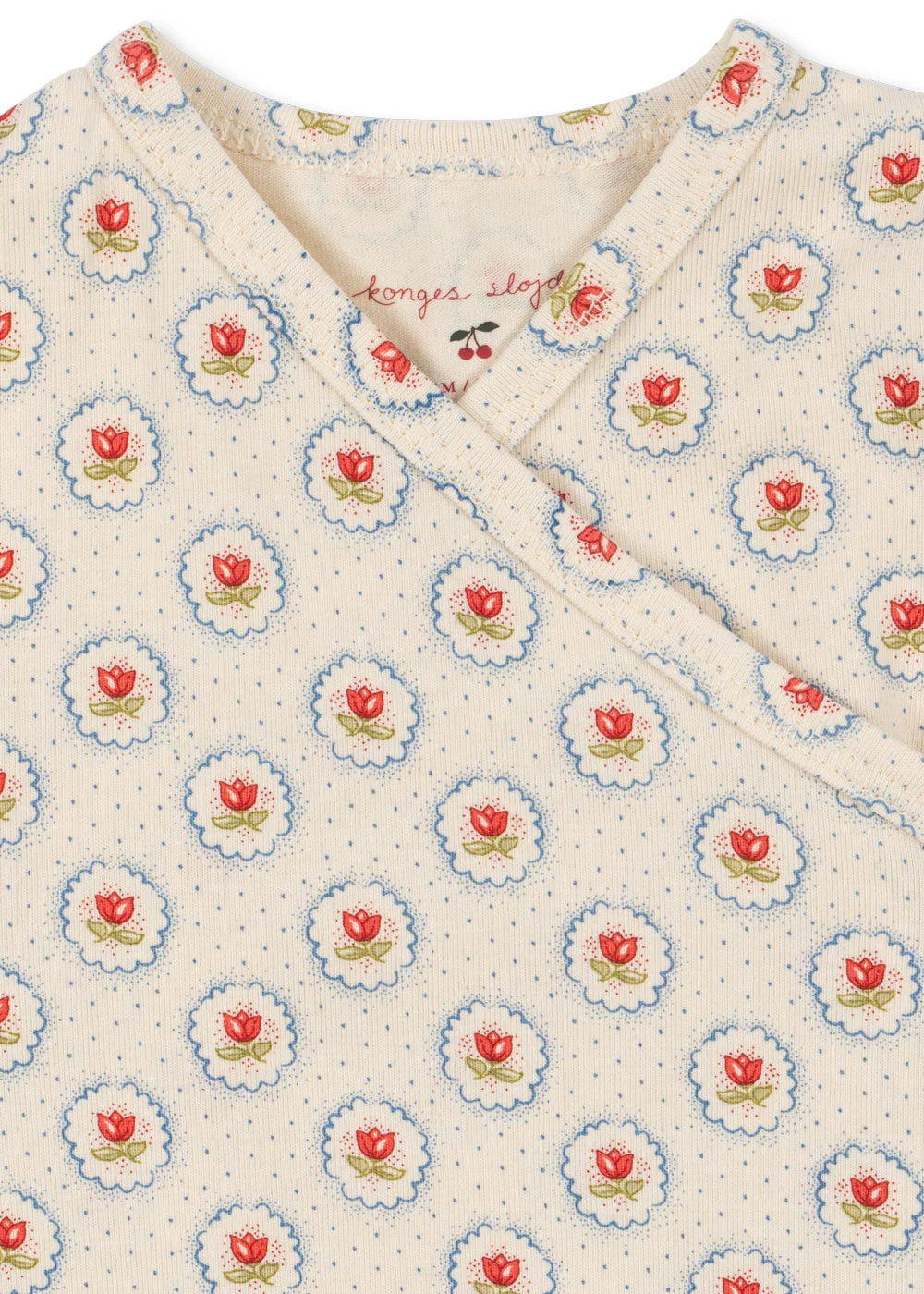 Floral patterned fabric with red roses and blue centers on a white background