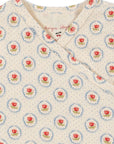 Floral patterned fabric with red roses and blue centers on a white background