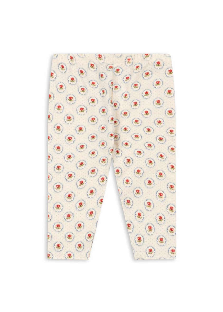 White pants with red floral pattern on a white background