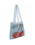 Beaded handbag with cherry design on a white background