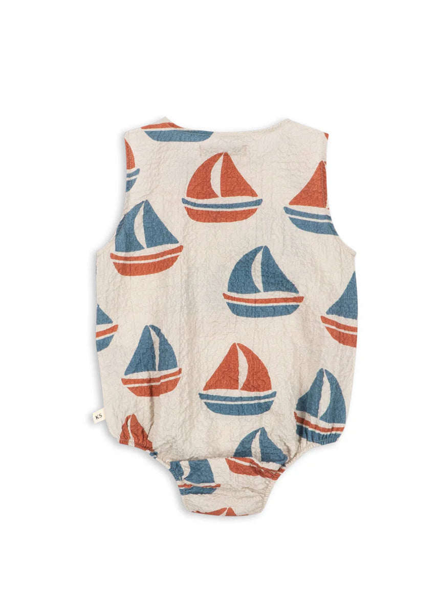 Baby romper with sailboat pattern on a white background