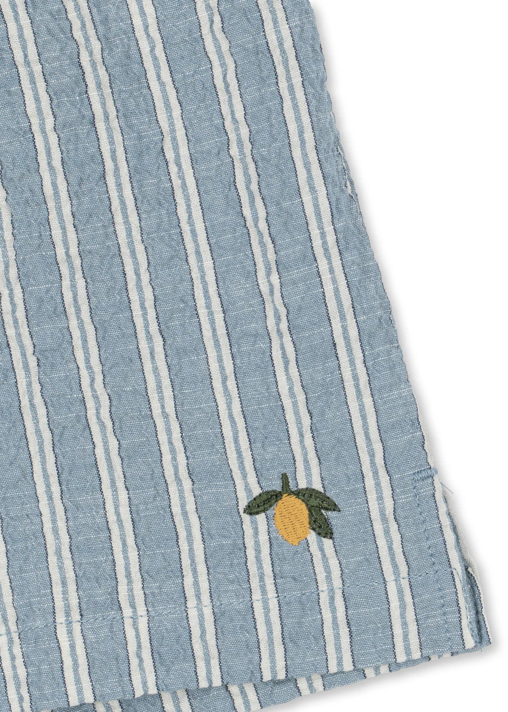 Blue and white striped fabric with a embroidered lemon design on a white background