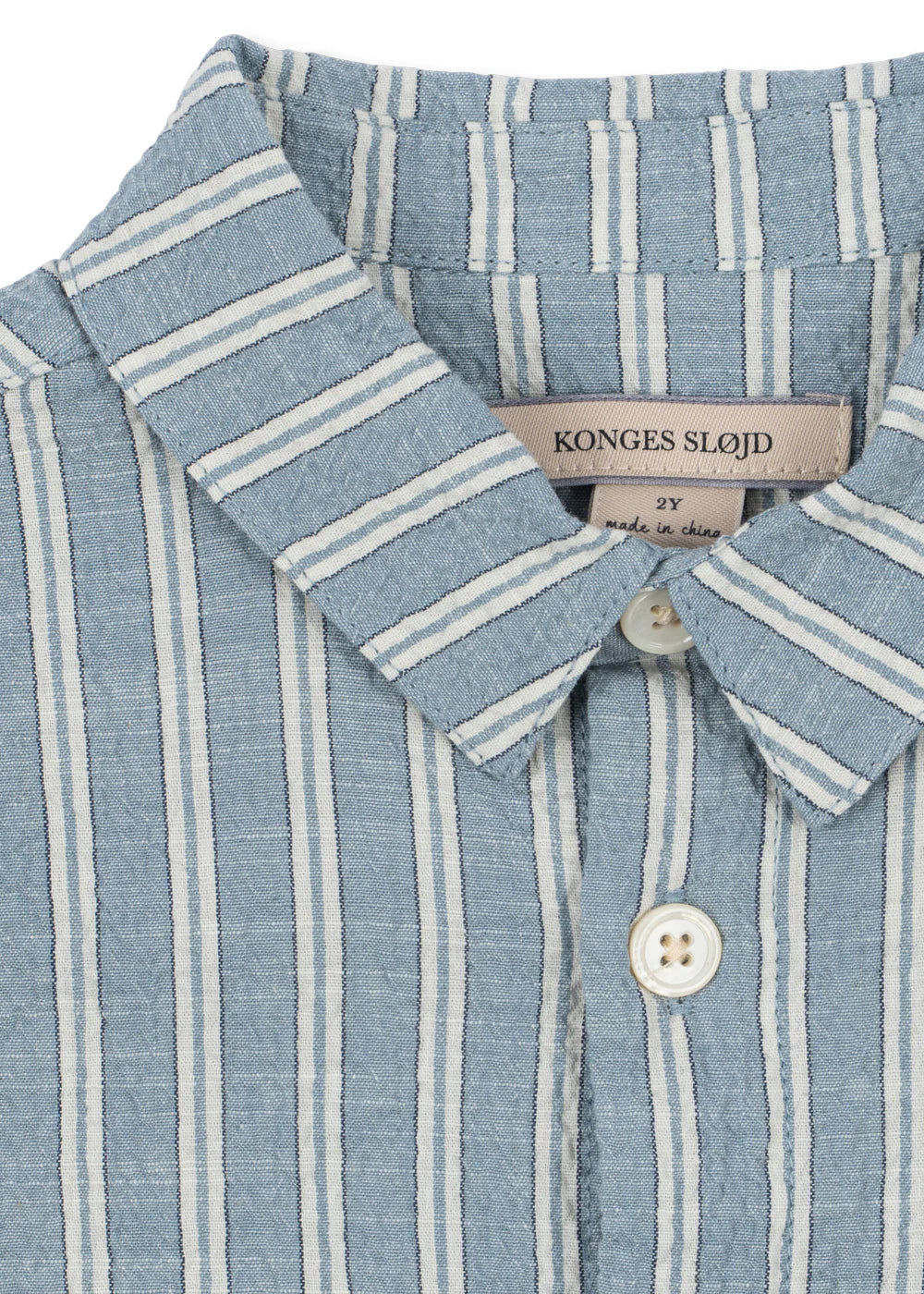 Close-up of a blue and white striped shirt with a visible brand label.