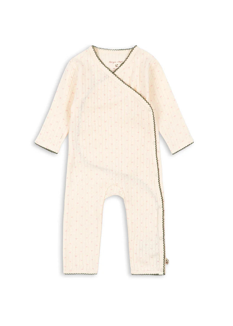 Beige baby romper on a white background