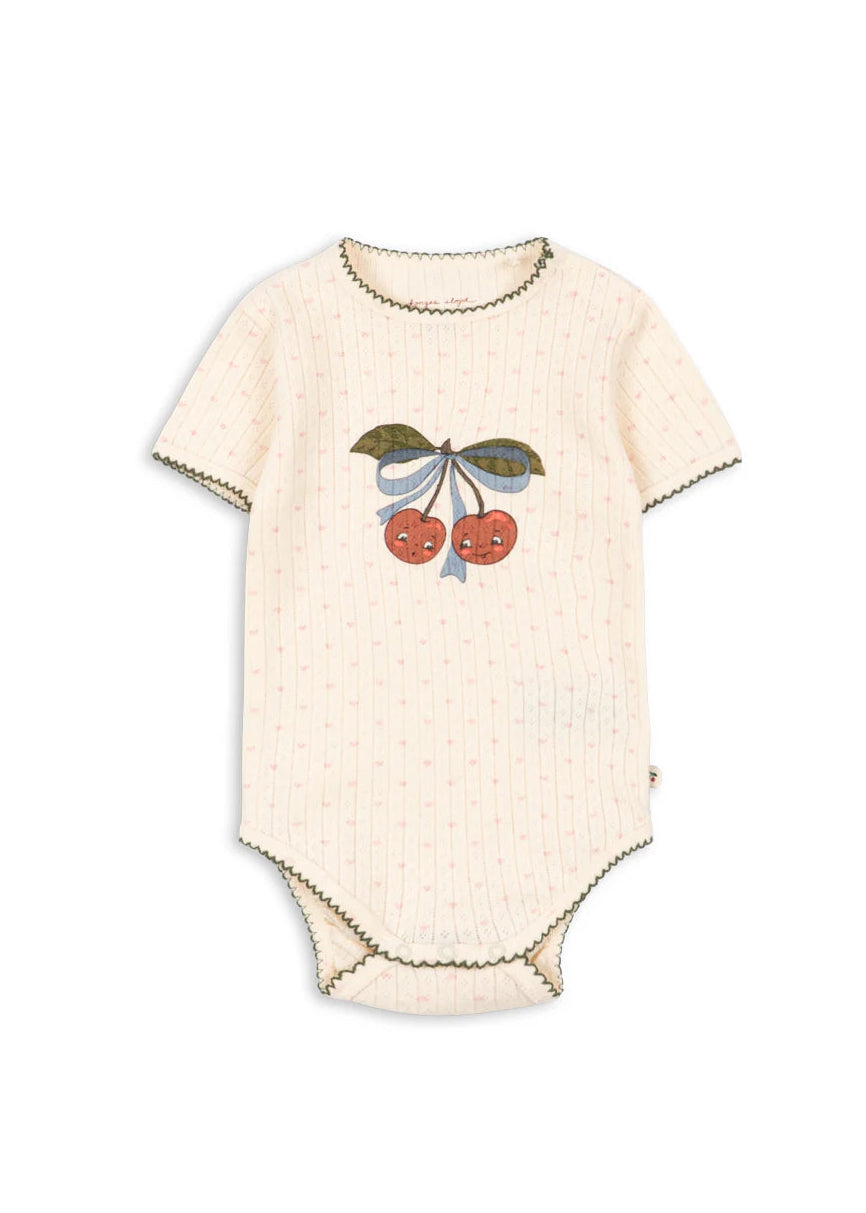 Beige baby onesie with cherry design on a white background