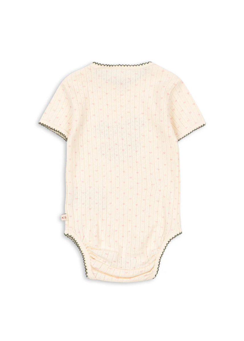 Beige baby bodysuit on a white background