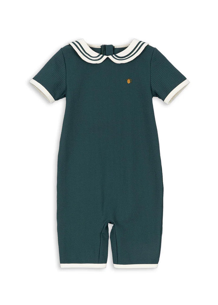 Green baby romper with white collar on a white background