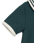 Green textured garment with white trim on a white background