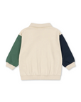 Beige sweater with green and navy sleeves on a white background