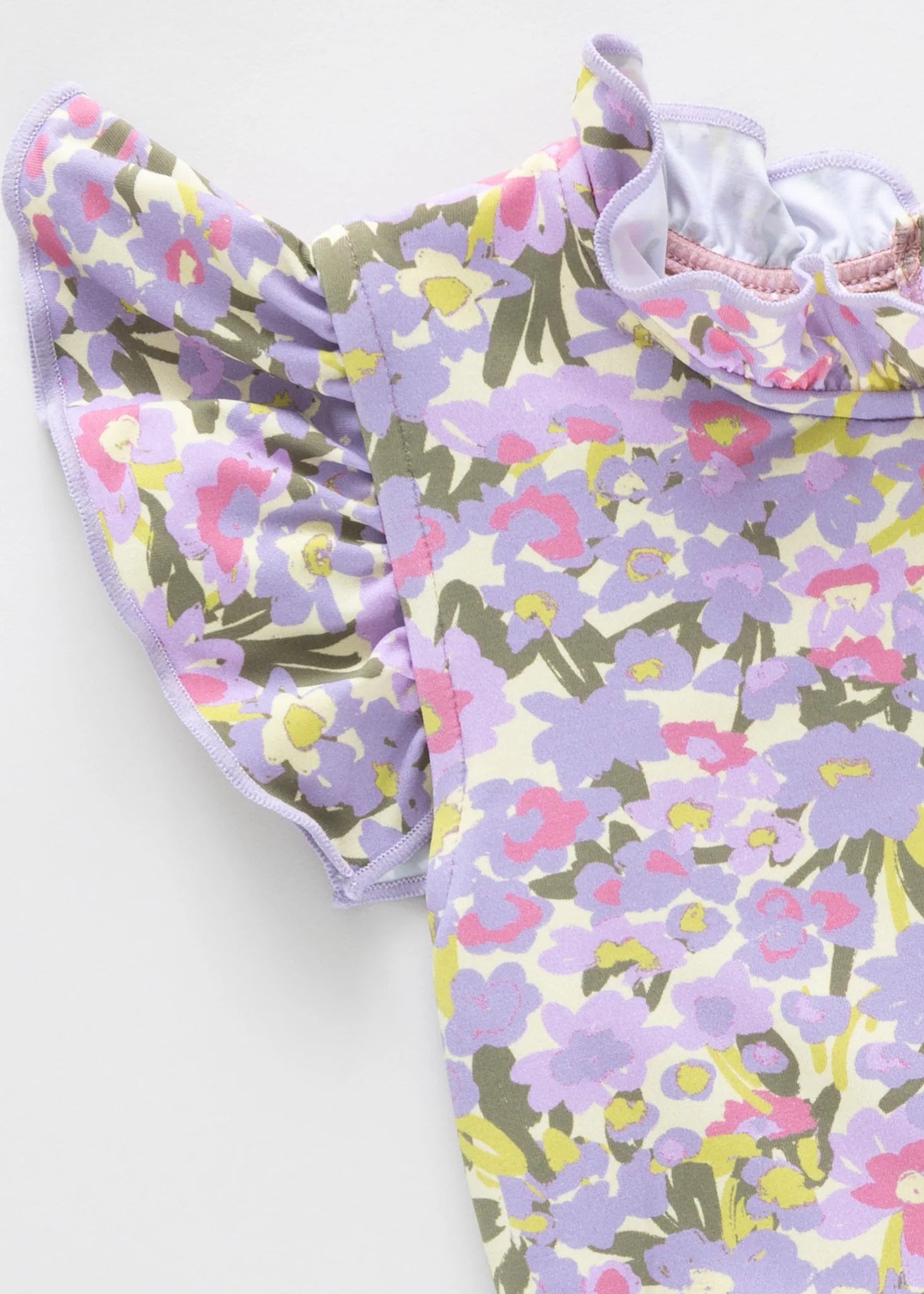 Floral-patterned baby romper on a white background