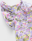 Floral-patterned baby romper on a white background