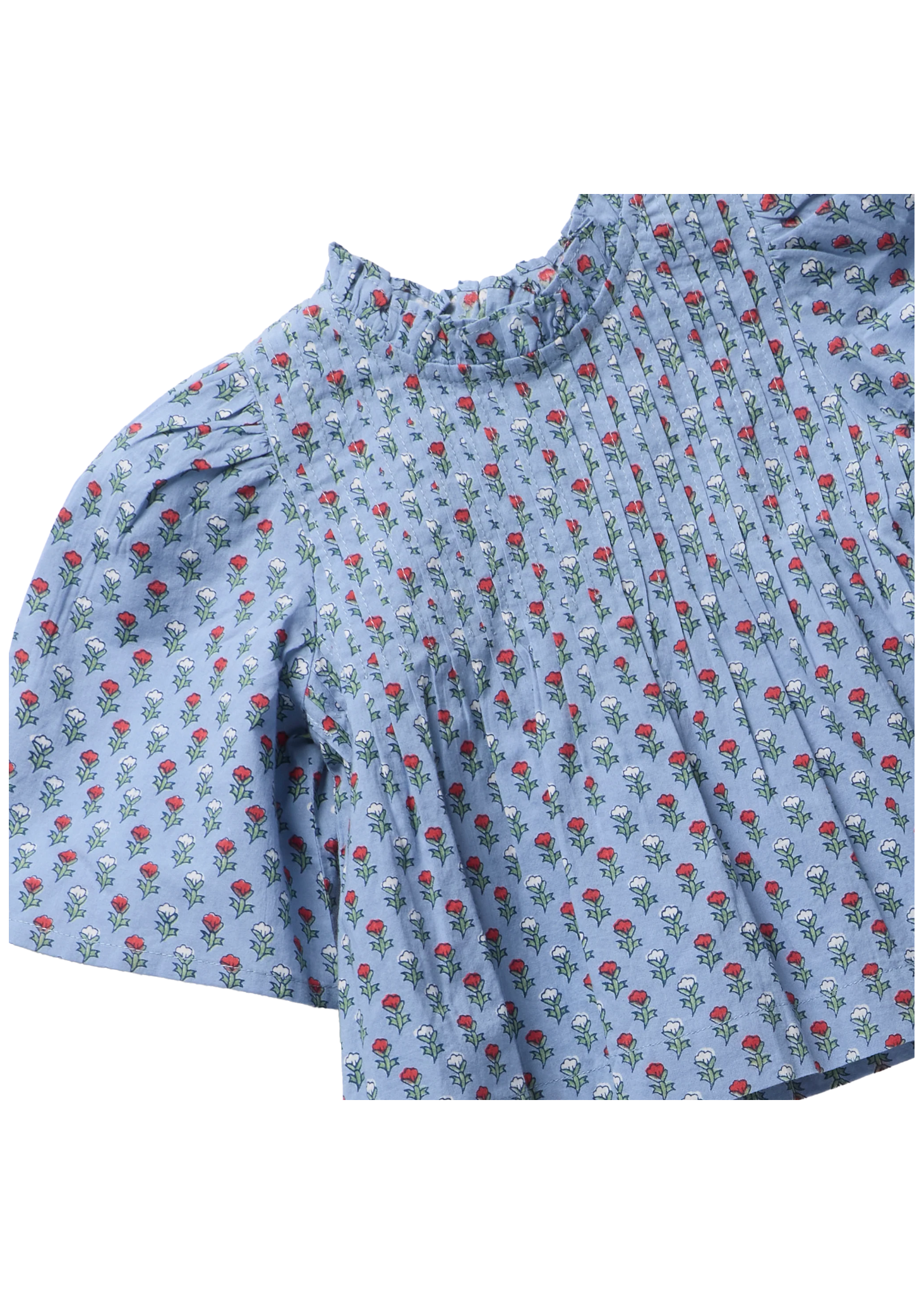 A close-up of a light blue short-sleeve blouse with a pleated texture and an all-over small floral print featuring red roses and white blossoms with green leaves.