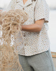 Person holding a bundle of twine or rope outdoors
