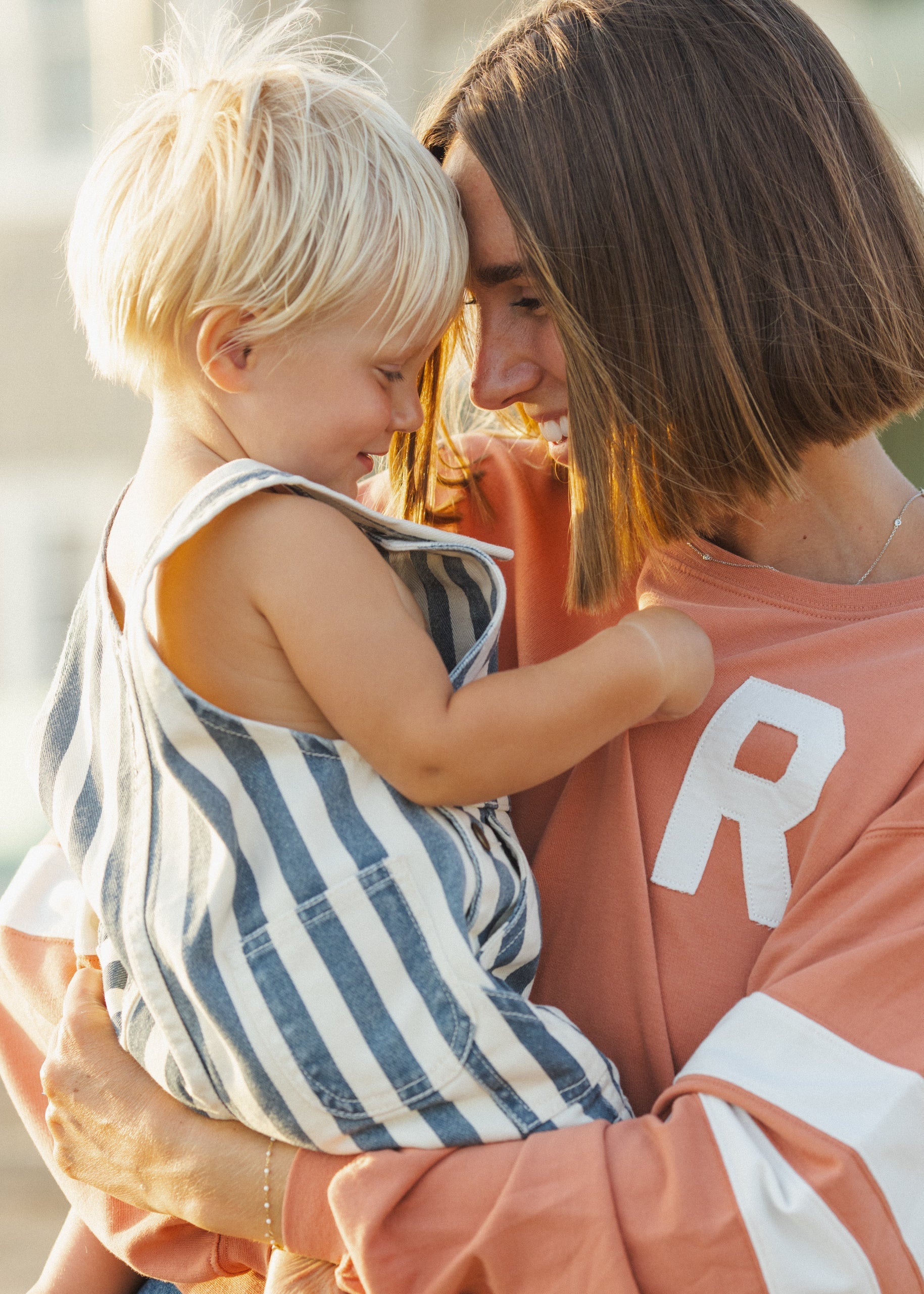 Woman holding a child with a blurred background