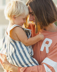 Woman holding a child with a blurred background