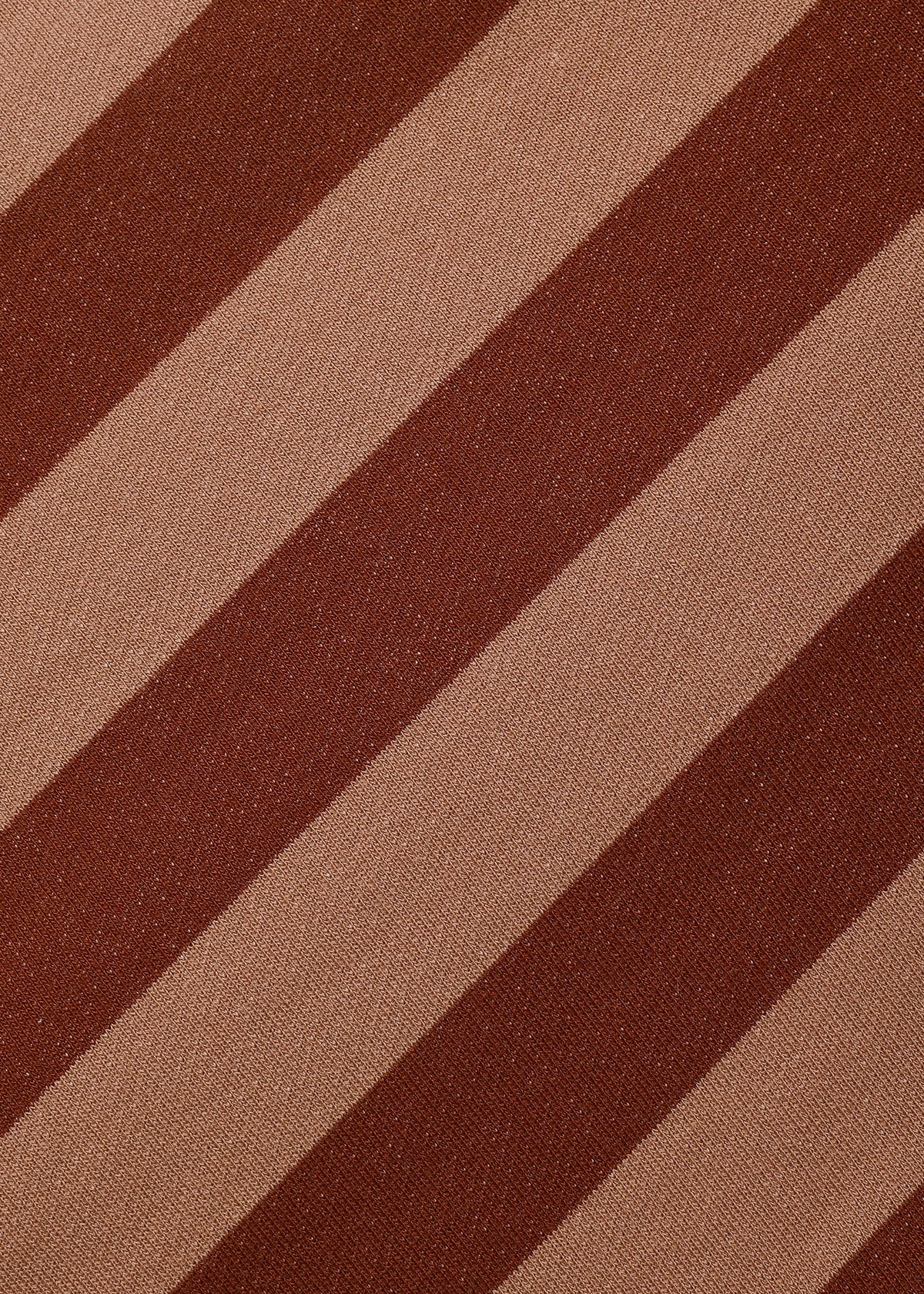 A close-up of a striped fabric pattern with alternating diagonal bands of dark brown and warm tan.