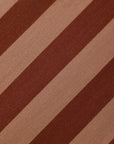 A close-up of a striped fabric pattern with alternating diagonal bands of dark brown and warm tan.